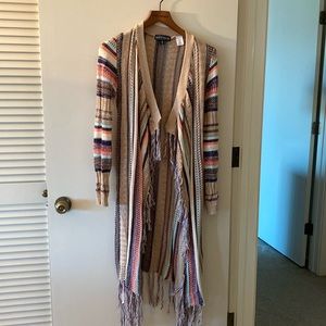 Open, long sleeve shawl.